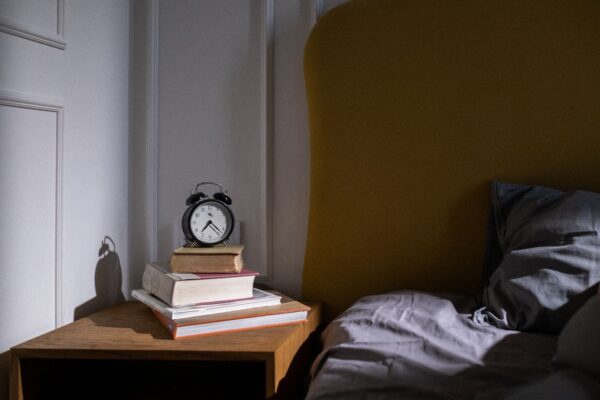 Wecker auf einem Nachttisch im Schlafzimmer
